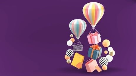 balloon, gift box and shopping bag surrounded by colorful balls on a purple background.
