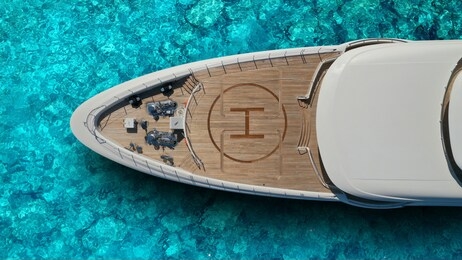 aerial drone top view photo of large yacht - boat with helicopter landing area docked in tropical exotic paradise with turquoise open sea