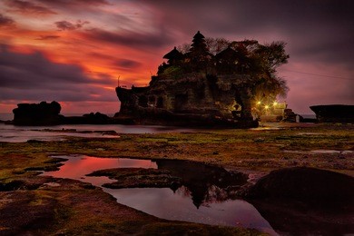 sunset over hindu temple pura tanah lot, bali, indonesia