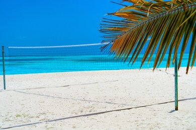 volleyball net on a deserted sandy beach on the tropical sea.