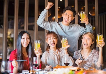 young friends having fun in hot pot restaurant