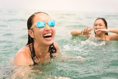 happy friends having fun in the water at the beach. 