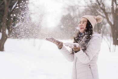beautiful young asian woman smiling happy with travel in snow winter season at hokkaido japan