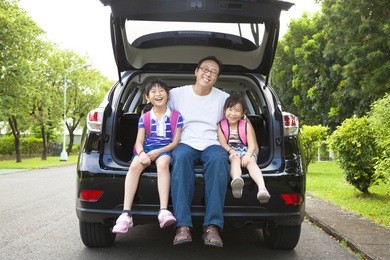 happy family sitting in the car 