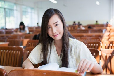 smiling chinese female college student in the classroom