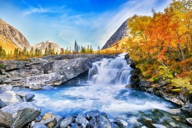 beautiful autumn landscape with yellow trees and waterfall