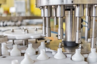 automatic line for filling and labeling drugs. the mechanism for filling plastic bottles.