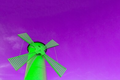 a bright green windmill against a purple sky, a concept of creativity and surreal architecture
