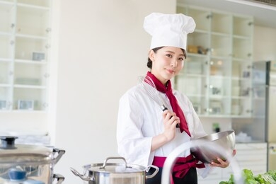 asian female chef in kitchen. cooking. restaurant.