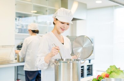 asian female cooking staff working in kitchen.