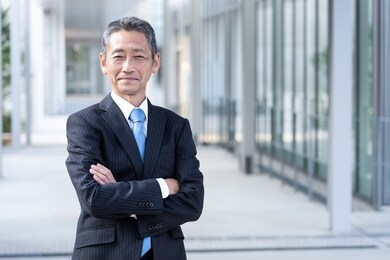 portrait of senior asian businessman standing 