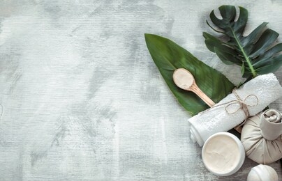 spa composition with body care items and plants on a light background. the view from the top.