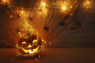 holidays halloween concept image. pumpkin, spiders over wooden table