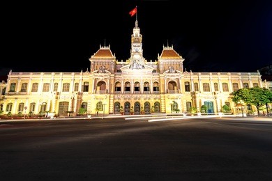 ho chi minh city hall in ho chi minh city, vietnam at night. it is known as ho chi minh city people's committee head office and was built in 1902-1908.