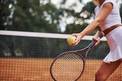 ready for the game. female tennis player in sportive clothes on the cort at summer daytime.