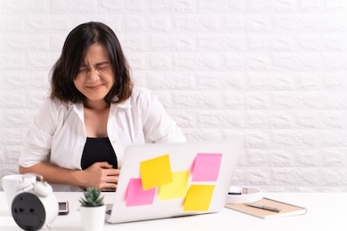 woman has stomachache at office