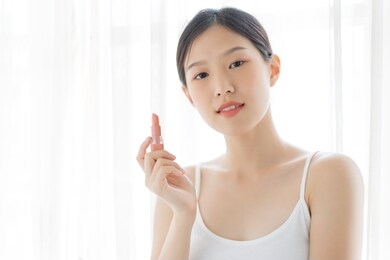 young asian female makeup beauty by lipstick