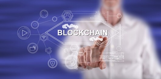 man touching a blockchain concept on a touch screen with his finger