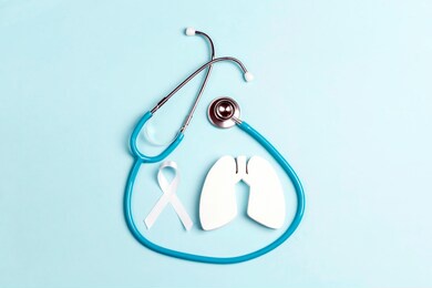 lung cancer awareness background with white ribbon and stethoscope on blue.  healthcare and medicine concept. 