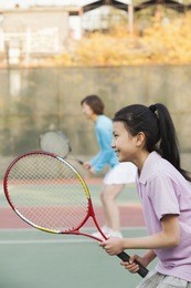 mother and daughter playing tennis