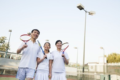 family playing tennis, portrait