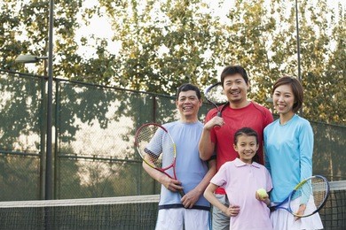 family playing tennis, portrait