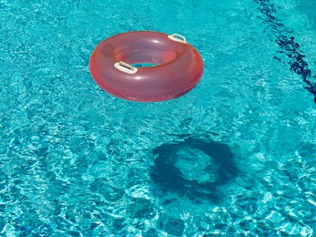 lifebuoy in swimming pool with shadow