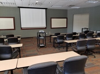 view to front of classroom with computer, projector, and projection screen for education technology