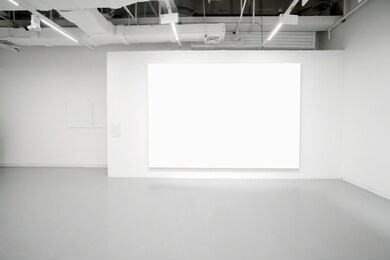 empty gallery interior space, white walls and grey floors