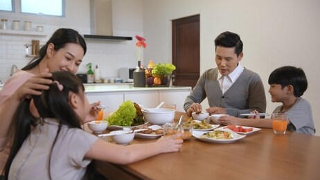 family concept. parents and children are eating together happily. 4k resolution.