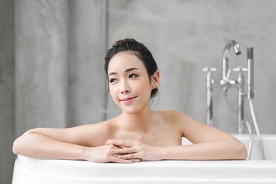 beautiful young asia woman enjoy relaxing taking a bath with bubble foam in bathtub at the bathroom