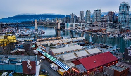 shot from above granville island market and vancouver skyline
