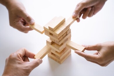 group of people building up the tower, business risk and strategy concept.