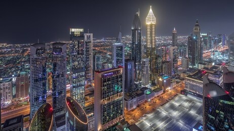 panoramic skyline of the buildings near sheikh zayed road and difc aerial night timelapse in dubai, uae. modern towers and illuminated skyscrapers in financial center and downtown
