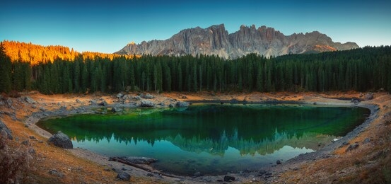 carezza lake in dolomitesn  or lago di carezza with reflection of mountains at sunset in the dolomites, south tyrol, italy.