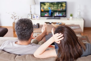 couple watching tv in living room