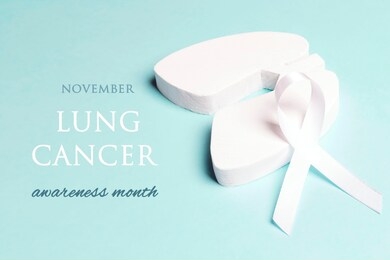 lung cancer awareness month in november. white lung cancer awareness ribbon and lung symbol on blue background.