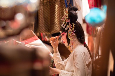 chinese opera dummy is doing the make up. this is a dummy, not a real person.