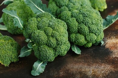 fresh green broccoli on a dark brown background. macro photo green fresh vegetable broccoli. green vegetables for diet and healthy eating. organic food. green vegetables