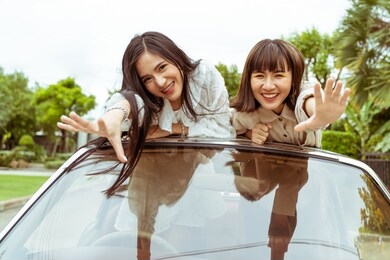 two young woman friends smiling with happy together in road trip.