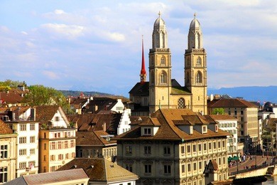 zurich cityscape with old buildings and the grossmunster cathedral , switzerland