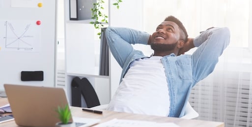 successful deal. satisfied african american office worker leaning on chair with hands behind head, relaxing after completed job, panorama