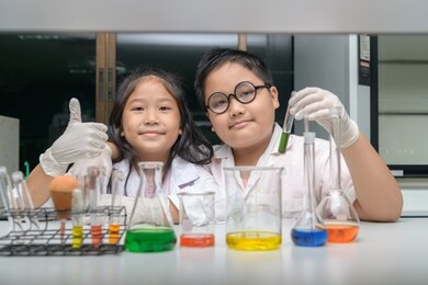 happy two children making science experiments. science and education concept.