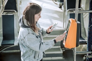 a young woman contactless pays for public transport. payment by card, bank transfer .