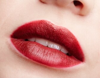 closeup macro portrait of female part of face. human woman red smiling, lips with day beauty makeup. girl with perfect lips shape.