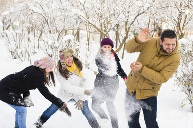 a group of young people playing in the snow