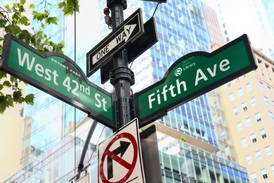 new york city fifth avenue and west 42nd street sign post.