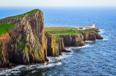 view of neist point lighthouse and rocky ocean coastline, highlands of scotland