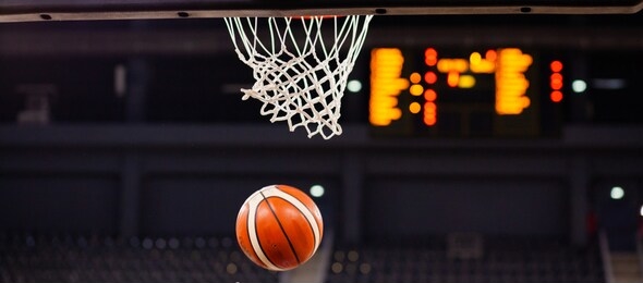 scoring during a basketball game ball in hoop
