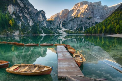 morning landscape of autumn picturesque mountain lake in dolomites alps on blue sky background